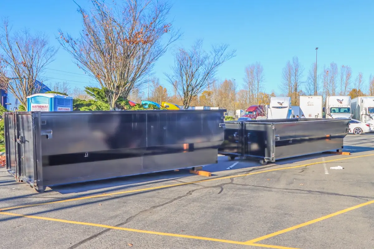 Professional dumpster rental service with roll-off container on residential driveway in Fort Worth